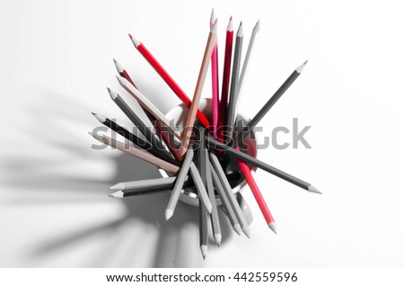 colored pencils in a glass isolated on business background