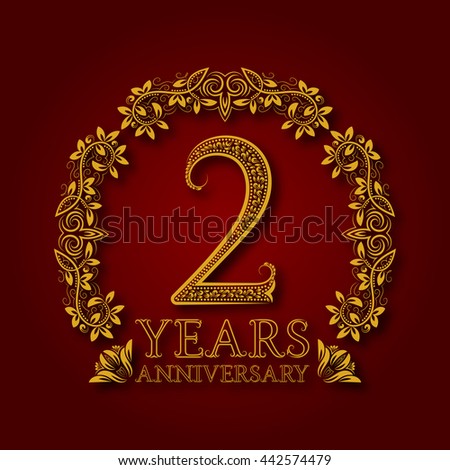 Golden emblem of second years anniversary. Celebration patterned logotype with shadow on red.