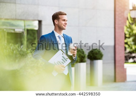 Handsome man standing near office building