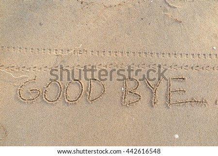 written words "GOOD BYE" on sand of beach