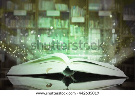 Image of opened magic book with glister lights.