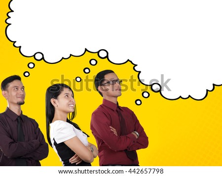 Dreams of success. Three business people looking up at empty white comic cloud / thought bubble for copyspace, over yellow background