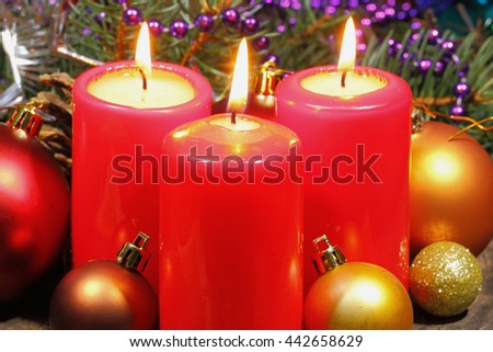 Advent candles with fir green and Christmas decoration