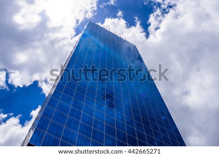 Reflection of cloud on mirror of the building with noon blue sky as background, great and fresh atmosphere for daily working