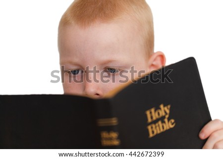 Little boy reading Holy Bible. Isolated on white. High quality picture