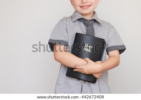 Casually Dressed Christian Boy Holding Holy Bible. High quality picture