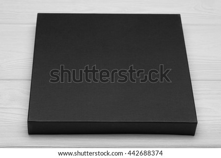 Template photo. Black flat box on white table. Mockup ready for your desigh