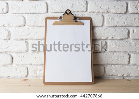 Wooden clipboard on wood background Royalty-Free Stock Photo #442707868