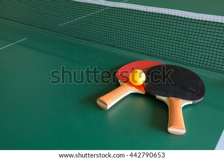 Ping pong ball with paddle on  table tennis Royalty-Free Stock Photo #442790653
