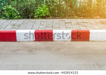 Red and White sign on the sidewalk background