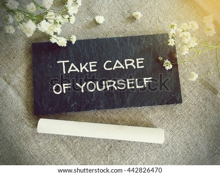 Blackboard for your text and flowers with words take care of yourself