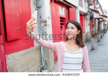 Woman taking selfie in Macau city