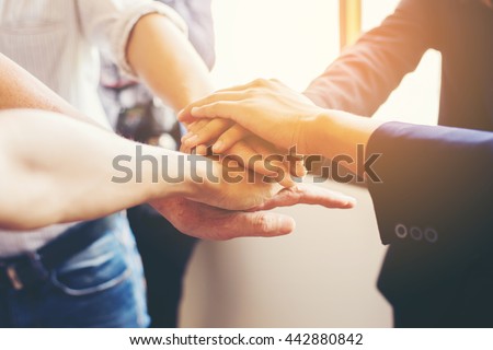  Concept of teamwork: Close-Up of hands business team showing unity with putting their hands together. Royalty-Free Stock Photo #442880842