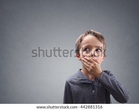 Shocked and surprised boy looking into copy space concept for amazement, astonishment, making a mistake, stunned and speechless or back to school Royalty-Free Stock Photo #442881316