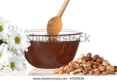 An image of flowers, nuts and honey