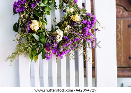 beautiful flower wreath on white wood wall 