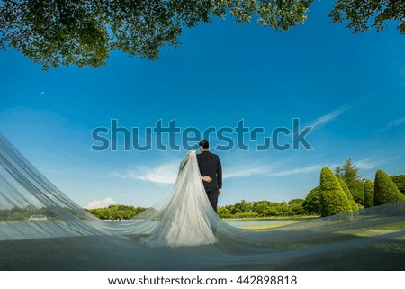 Couple stood hugging each other at the front of the symbol of love and marriage.