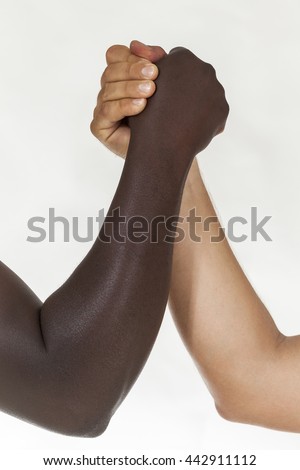 Interracial arm wrestling. White background