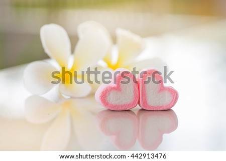 vintage tone of pink heart with soft plumeria flower background