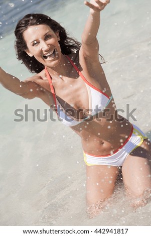 happy woman splashing in the sea