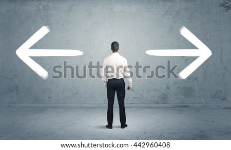 A businessman in doubt, having to shoose between two different choices indicated by arrows pointing in opposite direction concept