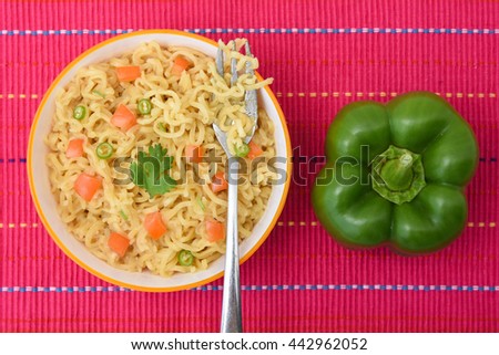 Hot and spicy Indian / Chinese noodles fried vegetables / instant with mushrooms, pepper and onion Mumbai, India. Asian meal. Traditional kids favorite junk food .