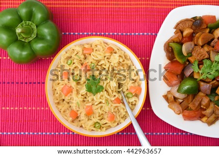 Hot and spicy Indian / Chinese  noodles fried vegetables / instant with mushrooms, pepper and onion Mumbai, India. Asian meal. Traditional kids favorite junk food .