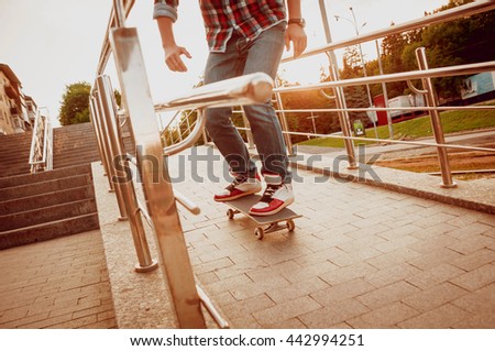 Young man riding a skateboard. Town Square