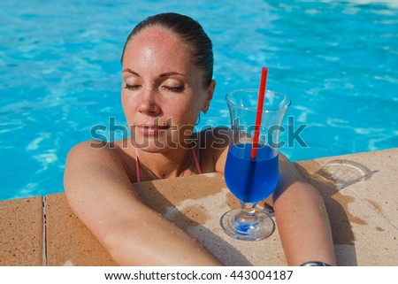 girl with cocktail near pool
