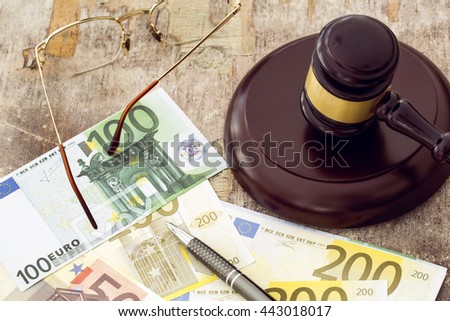 Labor law concept, gavel, clock and money on wooden table