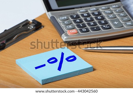 Marketing and sales concept: % percent. Silver calculator in background.