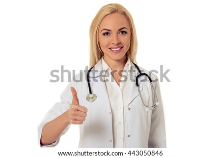 Portrait of beautiful female doctor in white coat looking at camera and smiling while showing Ok sign, isolated on white background