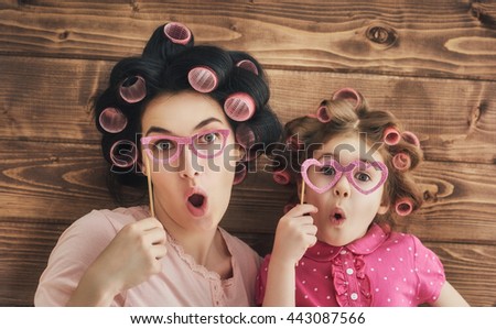 Funny family! Mother and her child daughter girl with a paper accessories. Royalty-Free Stock Photo #443087566