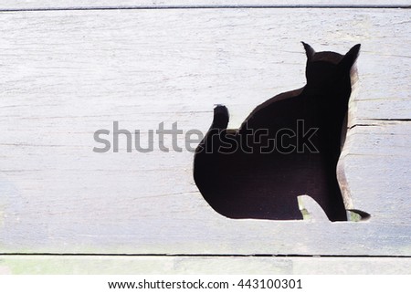 Front side of the wooden cat house with cat pattern door