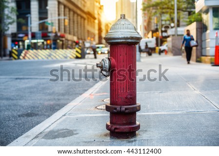 Old red fire hydrant in New York City street. Fire hidrant for emergency fire access Royalty-Free Stock Photo #443112400