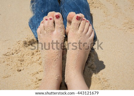 Picture of male and female legs over tropical beach background