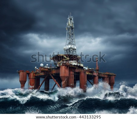 Offshore Oil Platform standing in the middle of ocean sea water during dark cloudy day, with high waves and storm Royalty-Free Stock Photo #443133295