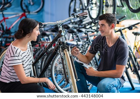 Couple looking for bicycle in bike shop
