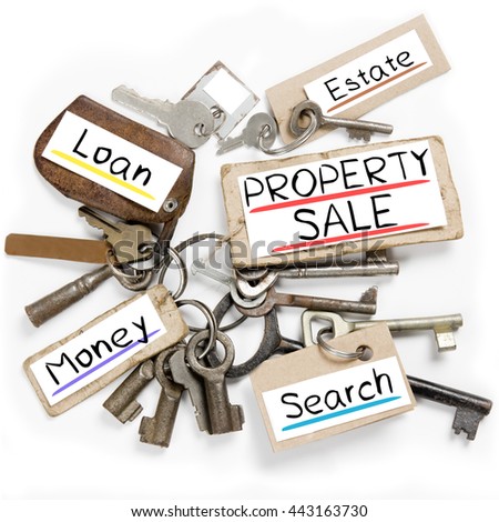Photo of key bunch and paper tags with PROPERTY SALE conceptual words
