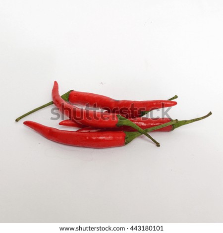 Red chilies or Cayenne pepper on the white background.It  is a type of Capsicum annuum. It is usually a moderately hot chili pepper used to flavor dishes either as a powder or in its whole form