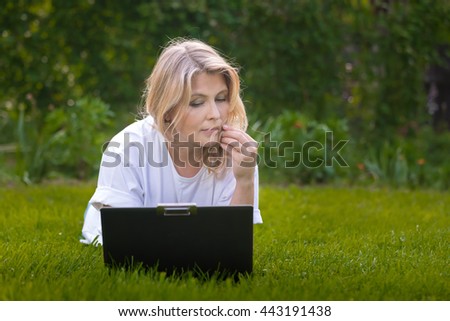 Woman with notebook on the grass