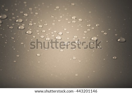 Drops of water on a color background. Gray. Shallow depth of field. Selective focus. Toned.