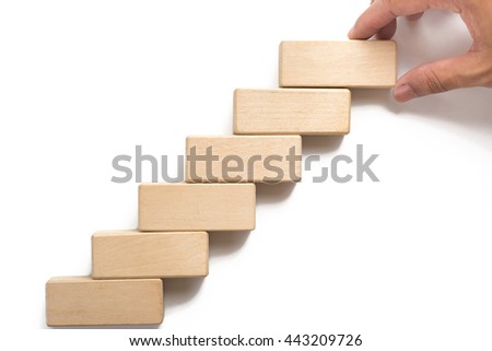 Hand aranging wood block stacking as step stair can use for presentation template or bullet or infographics. 