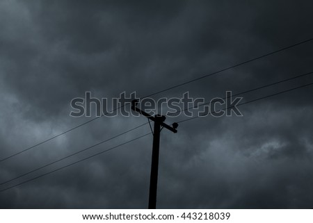 electric pole and  Dark sky before rain