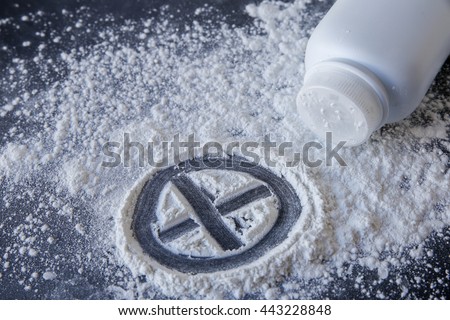 Talcum powder with cross sign on black background
