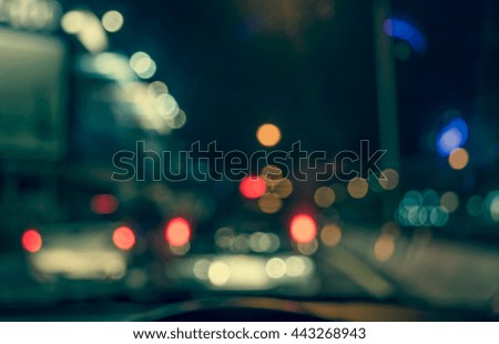 blur image of inside cars with bokeh lights with traffic jam on night time for background usage.