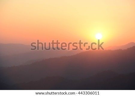 sunset silhouette  mountain landscape background with orange sky.