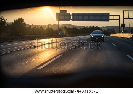 Cars on a highway at sunset (shallow DOF; color toned image)