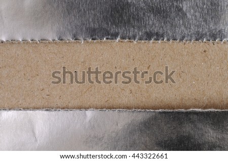 aluminum foil across recycle brown paper abstract background