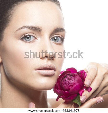 Beauty face of caucasian young brunette woman with peony flower in hand. Studio portrait. Isolated on white background. 